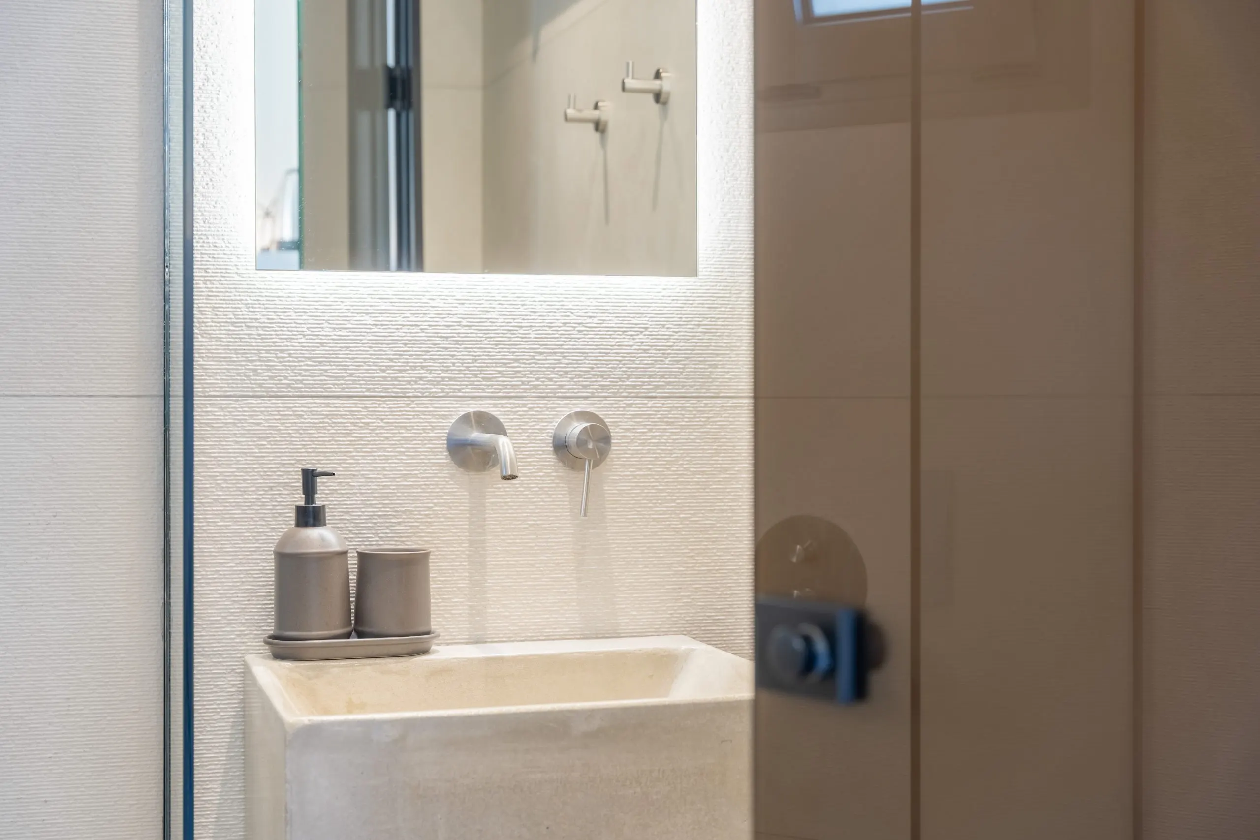 Bathroom with a stone basin and warm lighting