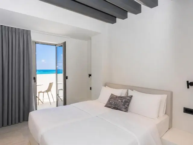 Apartment bedroom with balcony doors to the sea