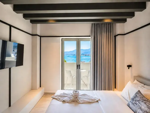 Bed by the balcony doors, facing the sea